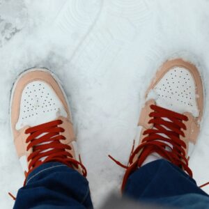 Pair of sneakers standing on snow