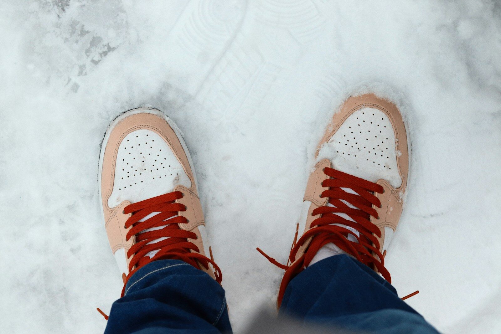 Pair of sneakers standing on snow