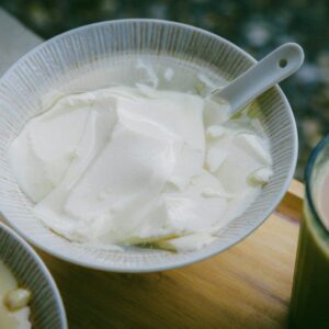 A bowl of yogurt on a table.