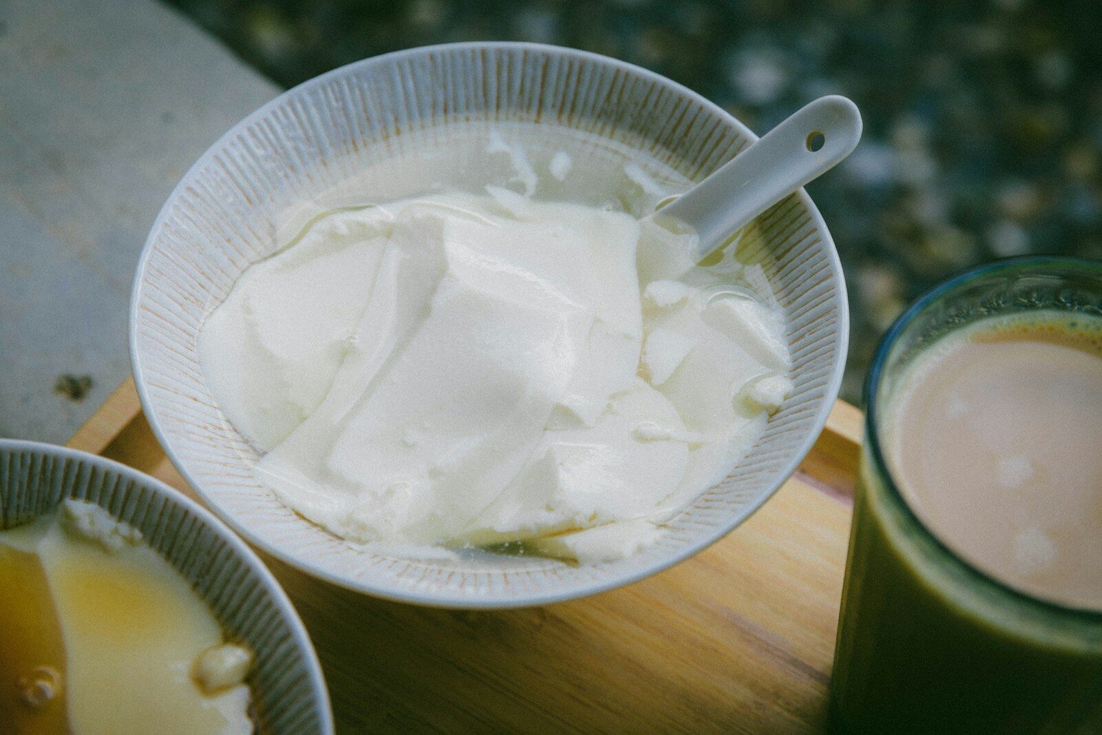 A bowl of yogurt on a table.
