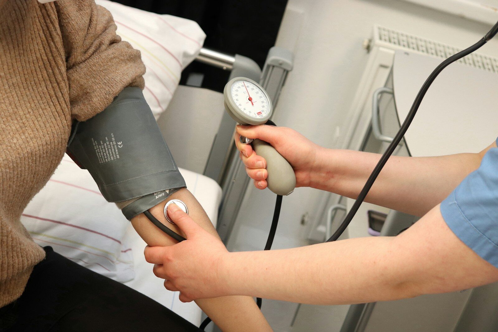 A person with a blood pressure monitor